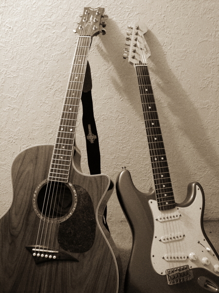 Acoustic and electric guitars displaying side by side